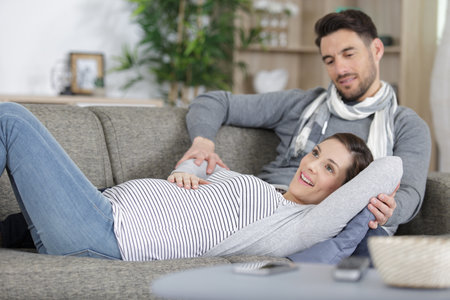couple joyful to feel their baby move in ladys tummyの写真素材