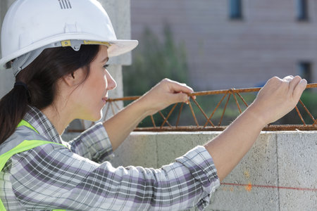 woman working on metal structureの写真素材
