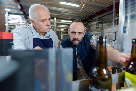man explaining to coworker at brewery