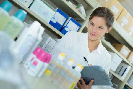 woman pharmacist is holding a notepadの写真素材
