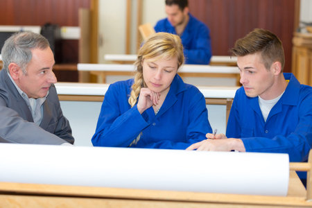 young apprentices with mentor in workshop