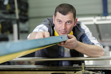 factory man worker holding metal sheet in workshop