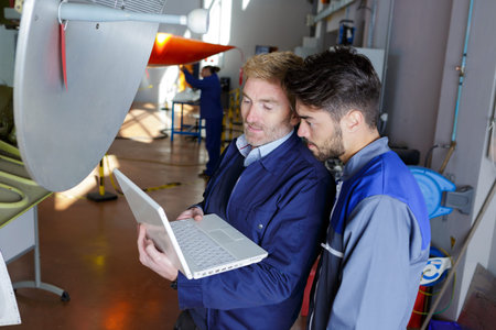 portrait of men fixing an issue