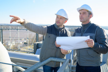 worker with manager inspecting industrial area