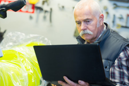 mature man shopping for laptop computerの写真素材