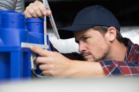 contractor measuring a ventilation unit