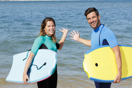 portrait of a successful couple of surfers