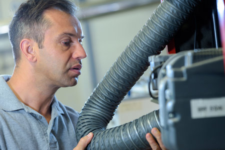 male engineer checking flexible hoseの写真素材