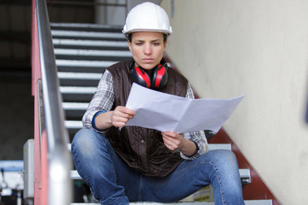 woman reading paperwork at a factoryの写真素材