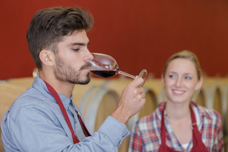 man sampling wine in cellarの写真素材