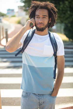 man crossing road on the phone