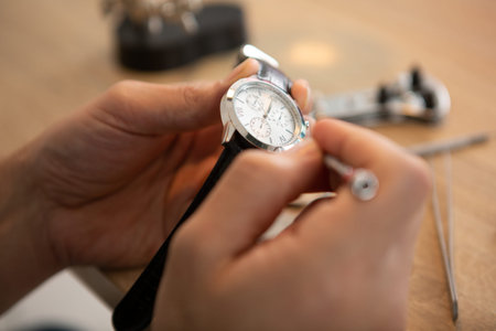 close up of hands holding tweezers