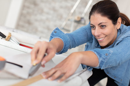 young woman using a spirit level and markingの写真素材