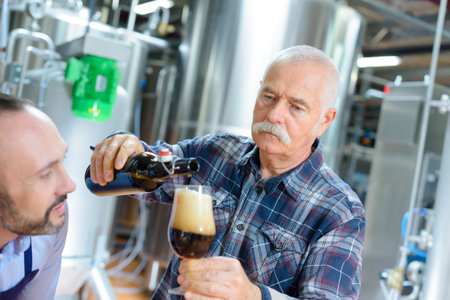 male quality control workers in beer factoryの写真素材