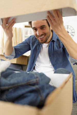 man receiving parcel at home