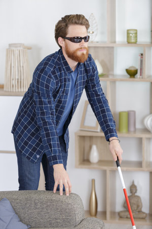 a blind man sit on the sofaの写真素材