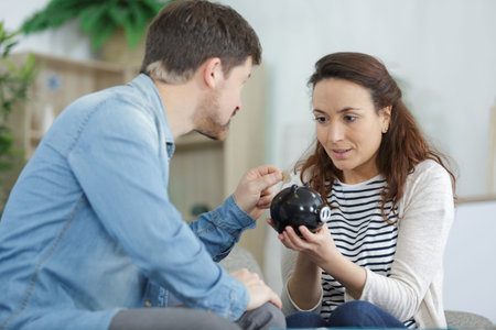 financial planning happy family couple with piggy bank at home