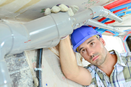 a plumber is with pipes