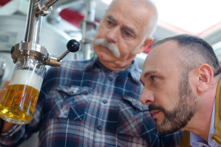 close up of industrial beer brewing workerの写真素材