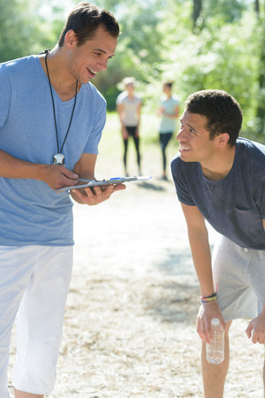 a coach talking to runner