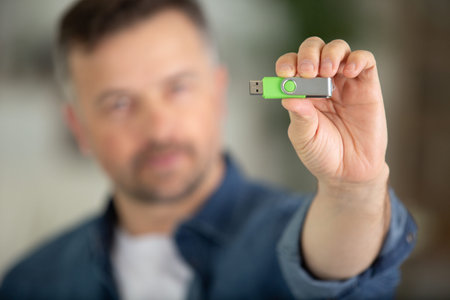 a man is showing a usb card