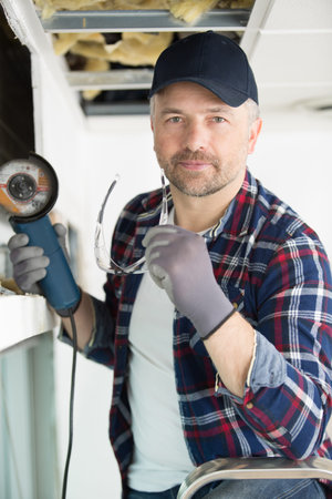young worker with earmuffs in noise canceling concept