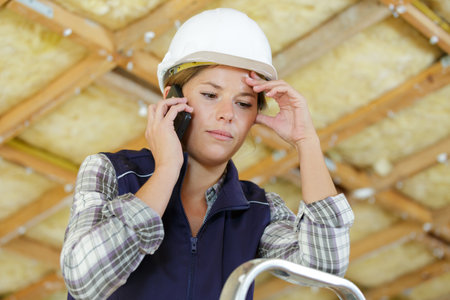 woman builder using smart phoneの写真素材