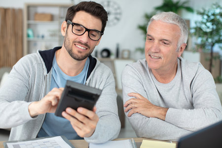 men crunching numbers working on financesの写真素材