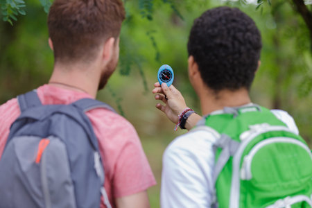 travelers holding compass in hand