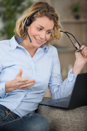 beautiful blond young business woman with headset at office