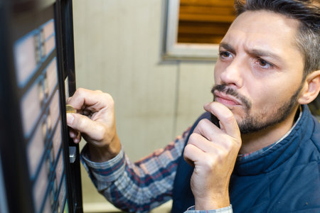 man standing in front of a vending machine