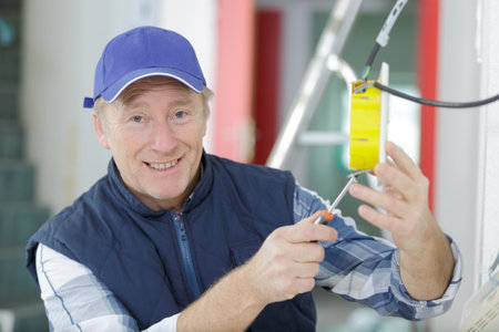 mature electrician working in renovation propertyの写真素材