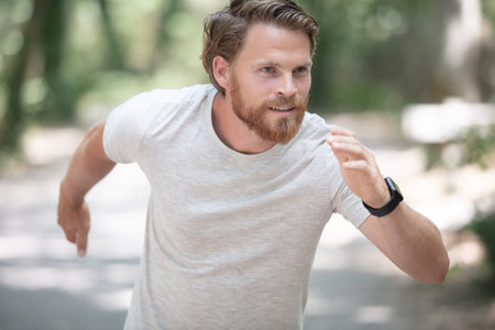 sport and fitness runner man running on road