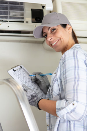happy female worker who confirms air-conditioning