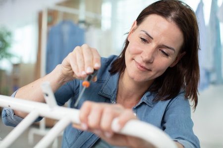 woman assembling a furniture using screwdriverの写真素材