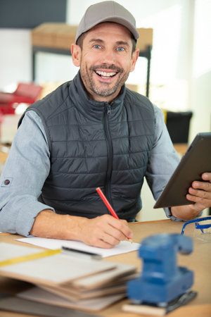 carpenter standing in his woodwork studio aの写真素材