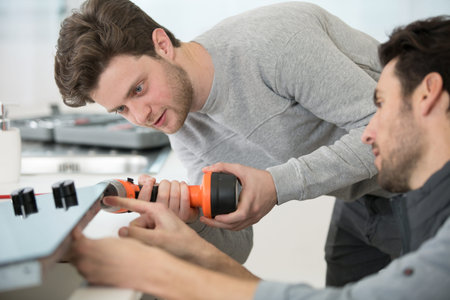 male technicians repairing a printer at business place at work