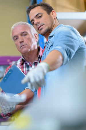 portrait of a factory department supervisor pointing