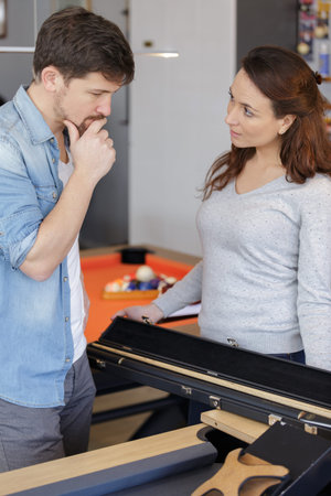 couple buying a snooker stick