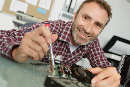 collage of smiling handsome computer technician at work