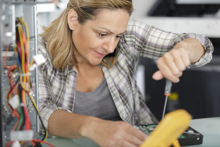 female computer engineer repairing broken desktop