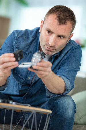 man holds small action camera selective focus