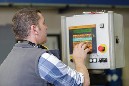 factory worker operating machine units in workshop
