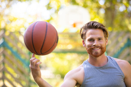 handsome male playing basketball outdoorの写真素材