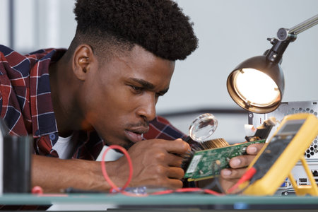 man with soldering iron microcircuit magnifying glass magnifying glass