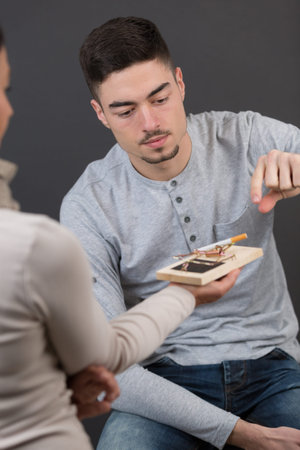 handsome man reaching for cigarette in a mousetrapの写真素材