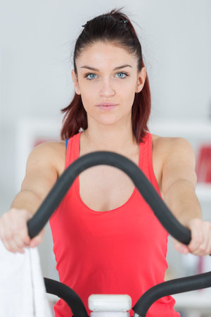 portrait of woman exercising on step machine