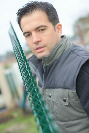 a man building a fenceの写真素材