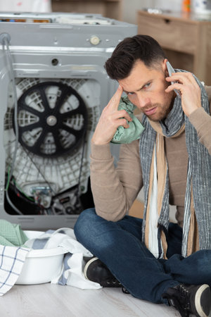 man on the phone calling plumberの写真素材