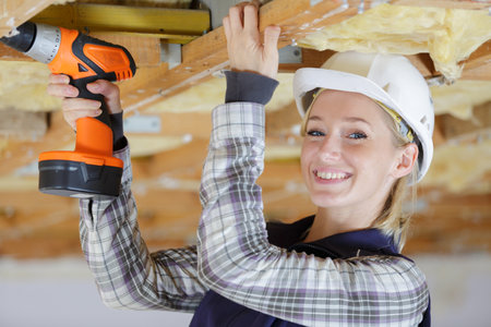 portrait of a happy female drilling indoorsの写真素材